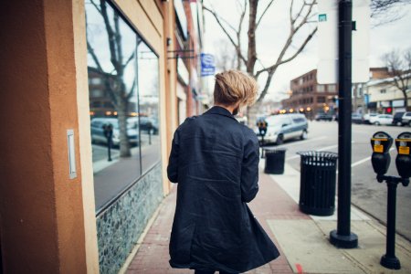 person walking beside street at daytime