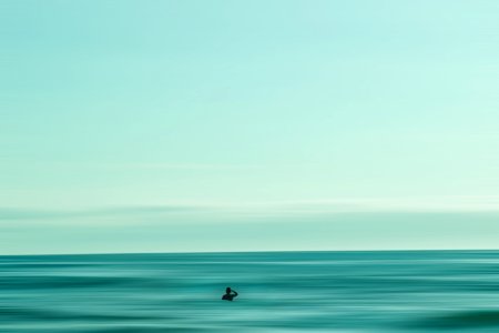 person in middle of ocean during daytime photo