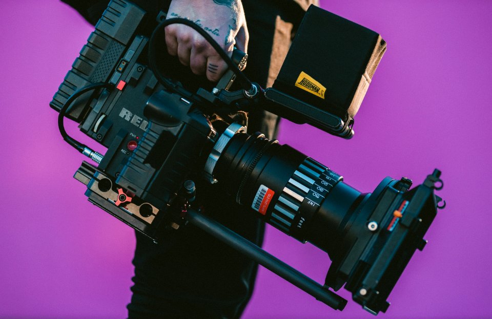 person carrying black camcorder