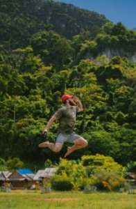 man in gray top jumping
