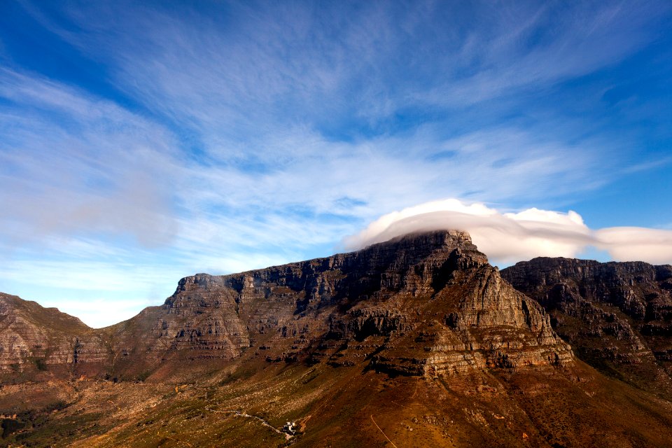 rock mountain under white and blue sky during daytime photo