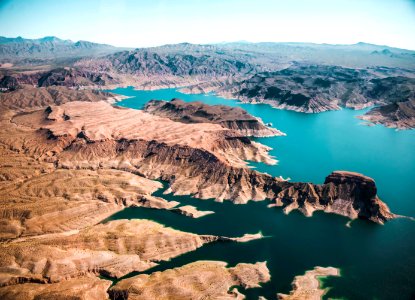 body of water surrounded with mountains photo