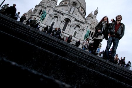 A couple standing in front of a historic French building. photo