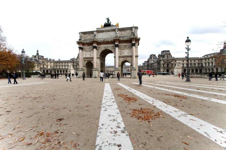 A bunch of people walking through a city in France. photo