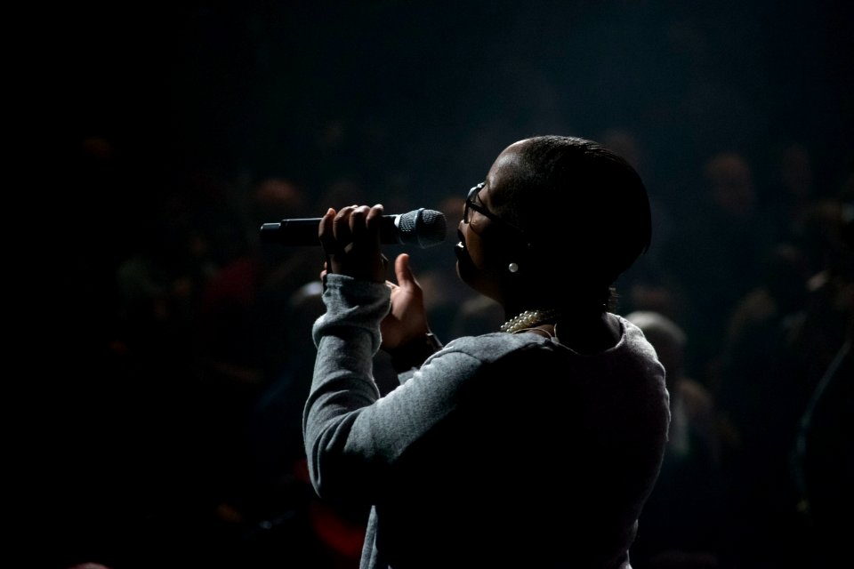 woman singing using microphone