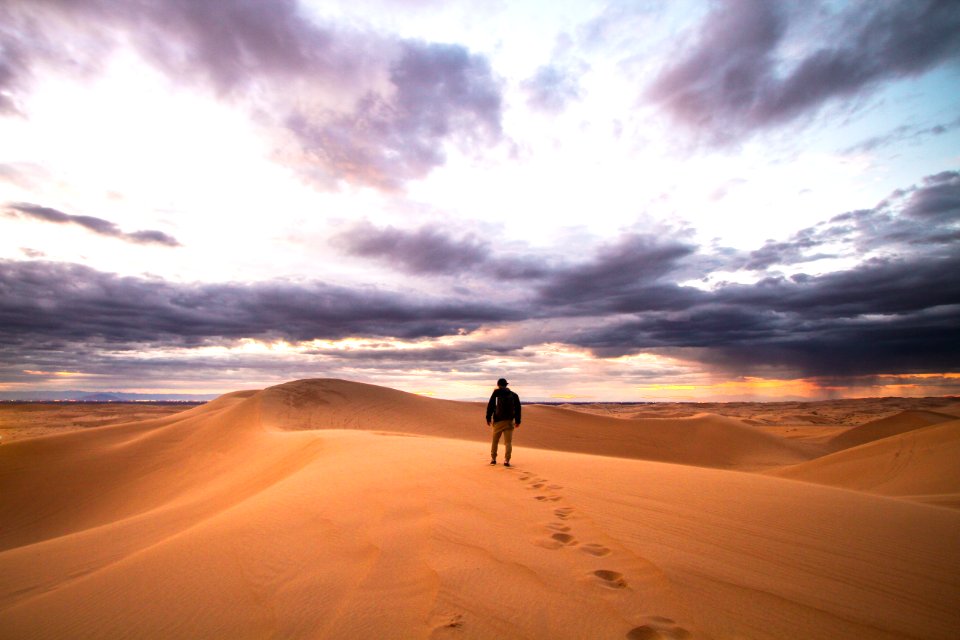 man walking on desert