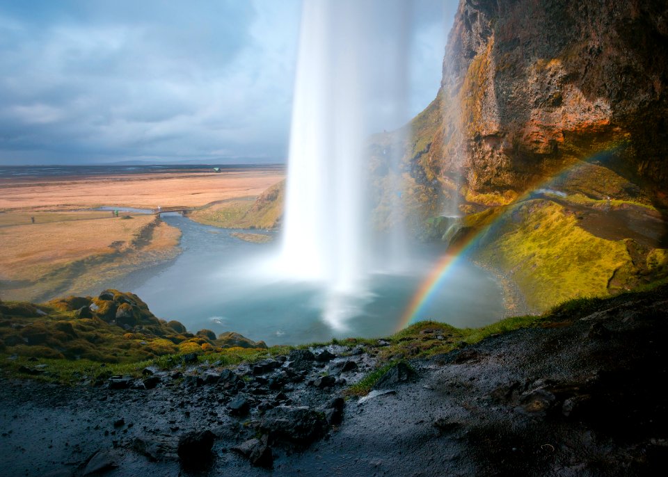 waterfall under grey sky