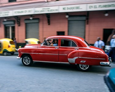 red sedan on the road photo