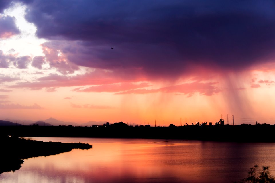 wide angle photo of body of water under cloudy sky