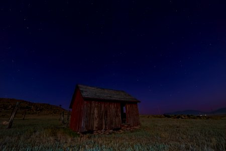 brown wooden shed on green grass field photo