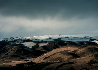 snow capped mountain under dim sky