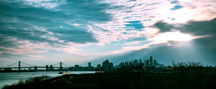 city skyline under white clouds and blue sky during daytime photo