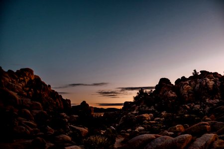 brown rocky shore during sunset