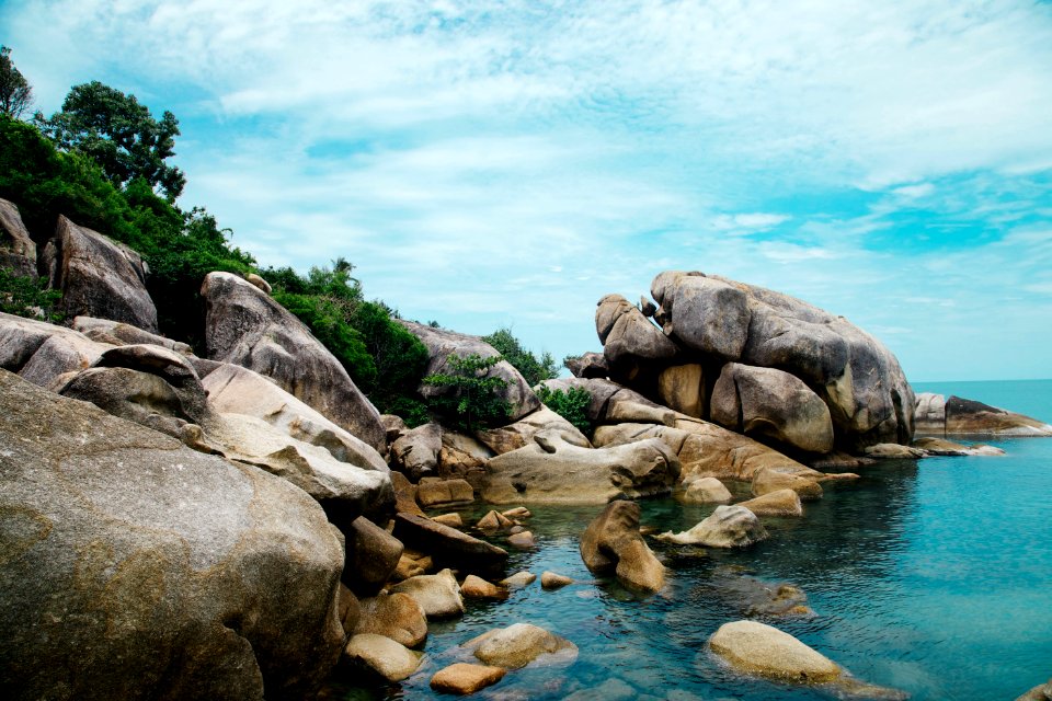 brown rocks near body of water during daytime photo