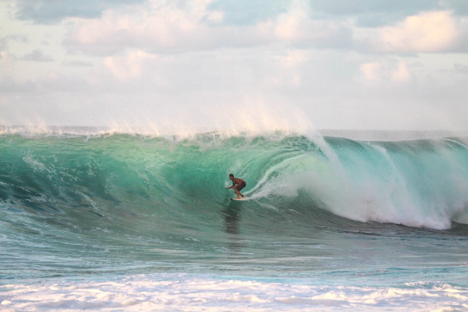 Person riding wave in Hawaii. photo