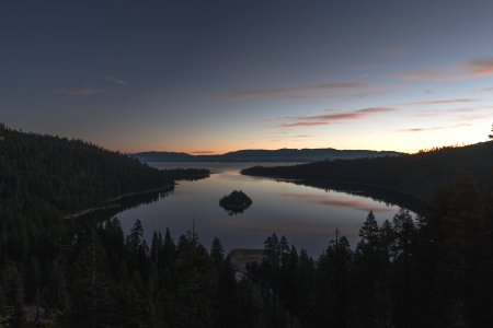 aerial view photography of lake surrounded by pine trees photo