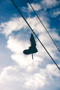black boot hung on wire photo
