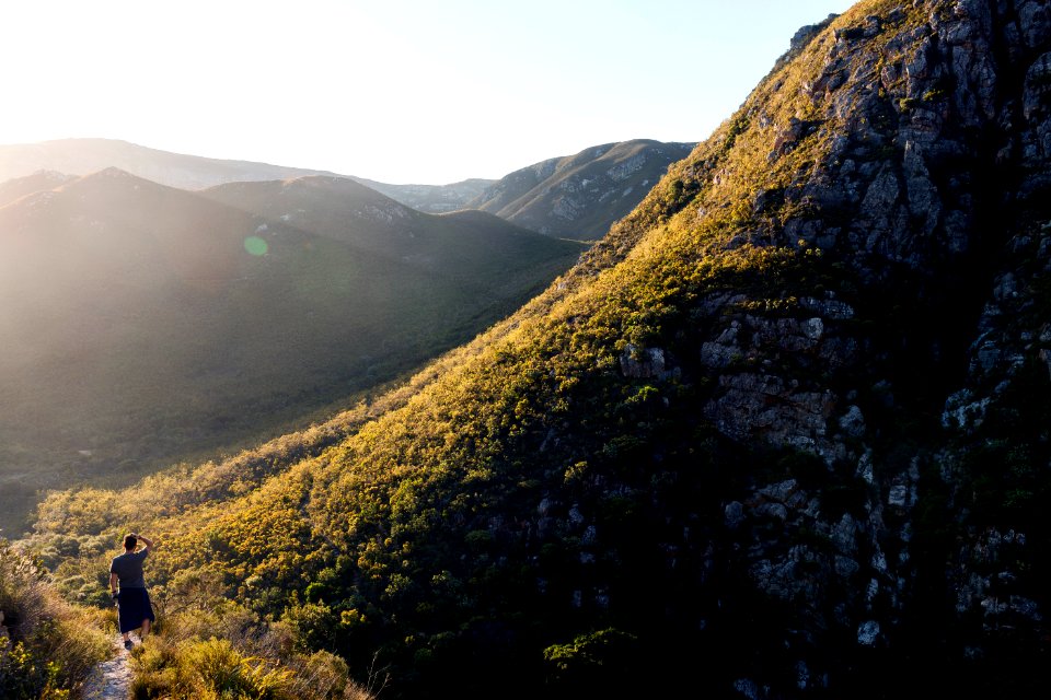 person standing on top of hill during day time