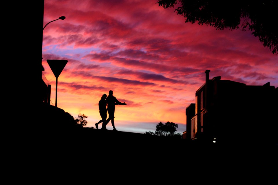 two persons walking near building