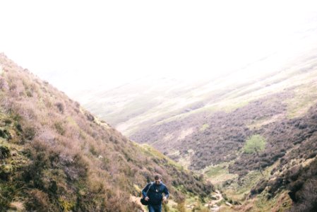 man walking on mountain during daytime photo