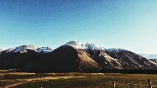 photo of mountain and green field