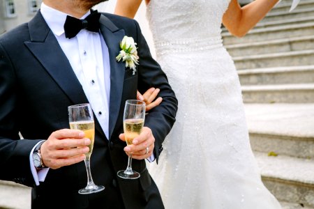 man holding two champagne flutes near woman photo