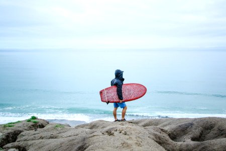 person holding surfboard photo