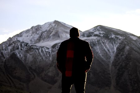 man standing while looking at the mountain photo