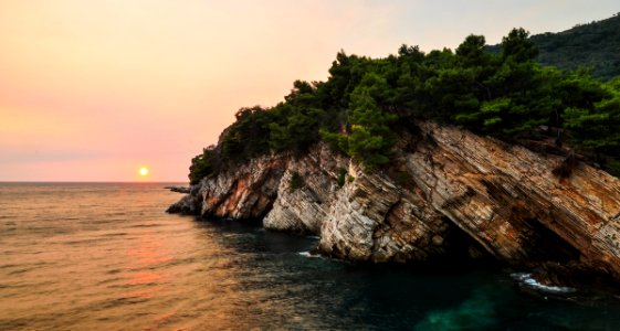 brown rock formation near body of water photo