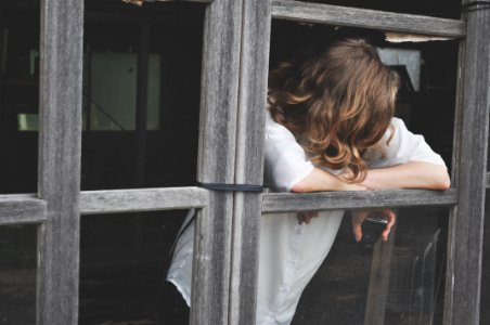 woman leaning on window photo