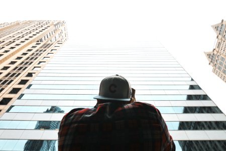 person near tall building during daytime photo