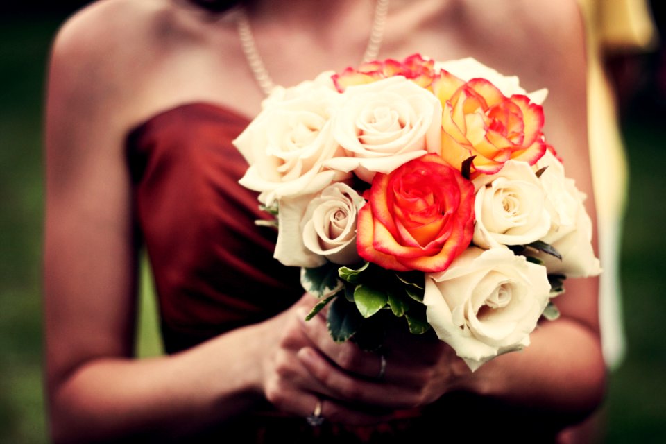 woman holding bouquet of flowers