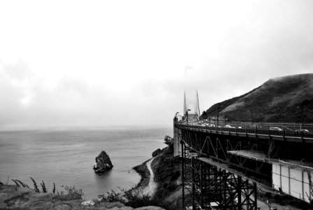 gray scale photo of bridge near body of water photo