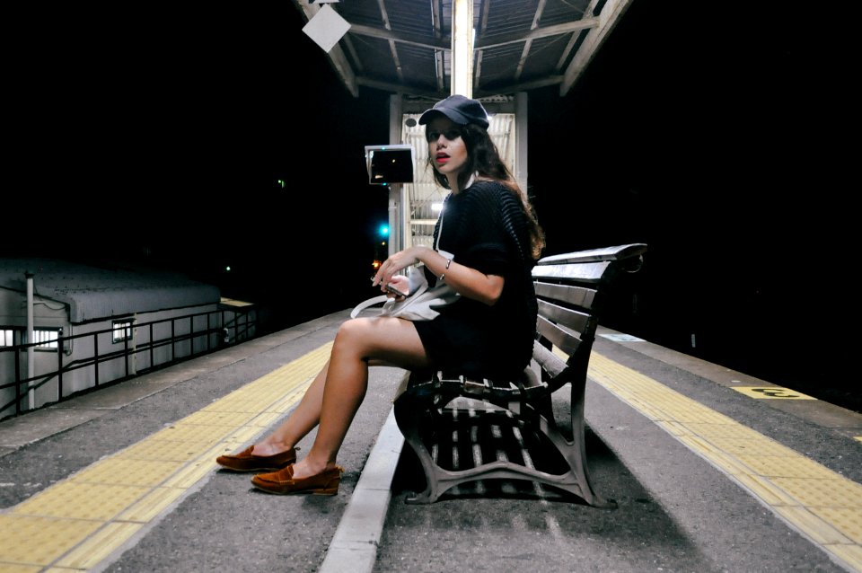 woman wearing black dress sitting on the