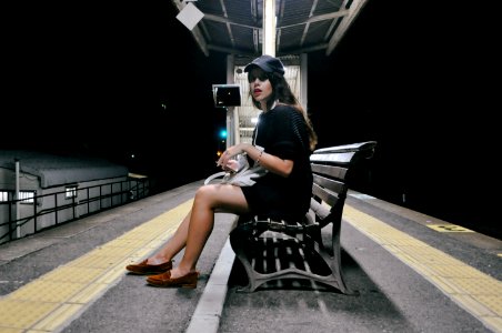 woman wearing black dress sitting on the photo