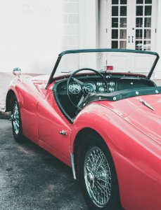 A red convertible parked outside. photo