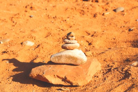 closeup photography of piling stone on sand photo