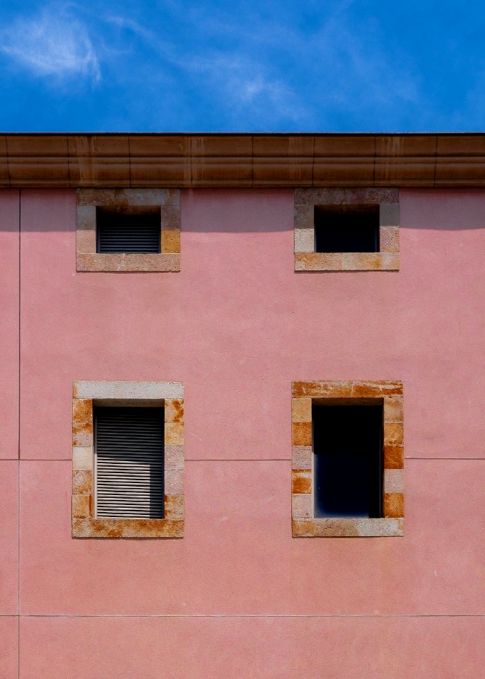 minimalist photography of concrete building with four windows