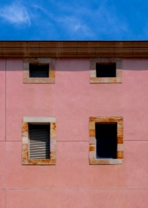 minimalist photography of concrete building with four windows photo