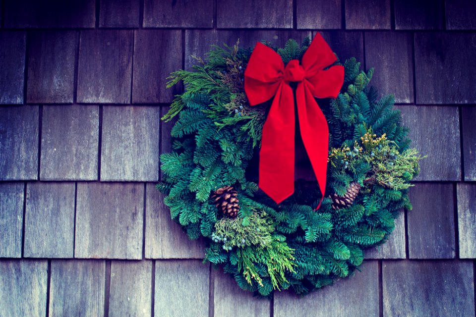 green and red Christmas wreath mounted on wall
