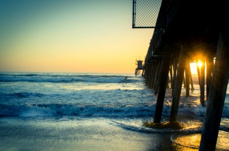 brown wooden sea dock during sunset photo