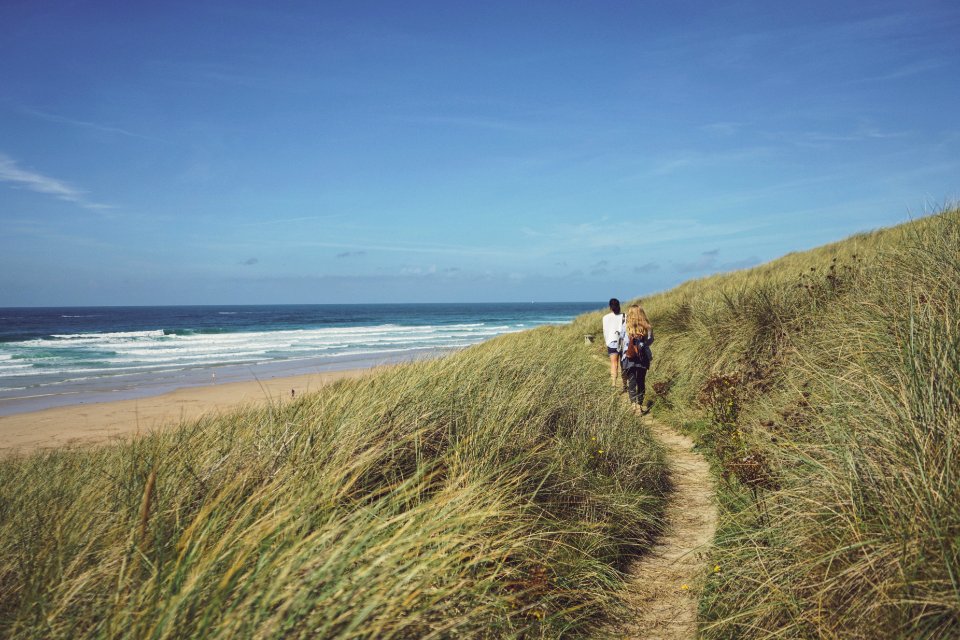 people walking between green grass near shore during daytime photo