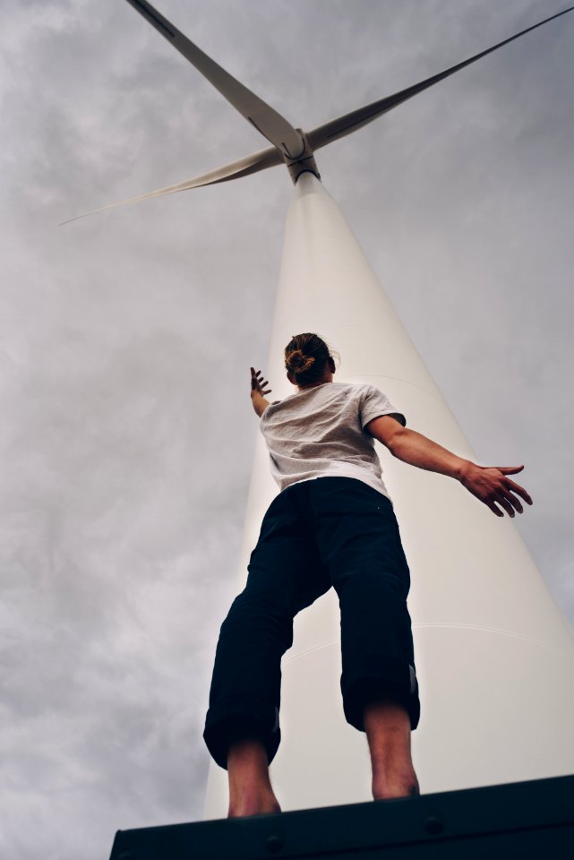 person standing on white wind mill photo