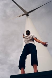person standing on white wind mill photo