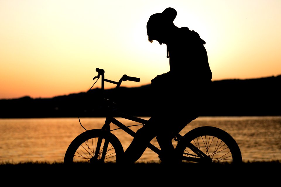 silhouette of man riding in bike
