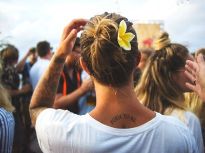 person raising left hand while standing beside woman wearing white top photo