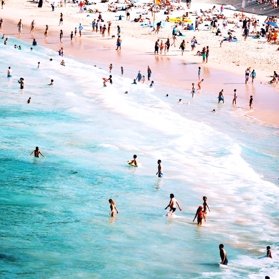 people standing beside body of water during daytime photo