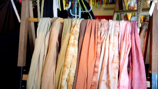 assorted scarves on brown wooden rack photo