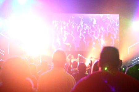 group of people having a party inside dark room with light effects photo