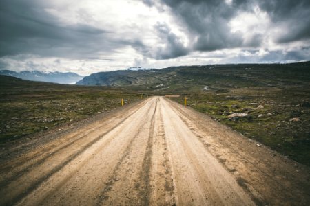 brown concrete road under cloudy sky photo